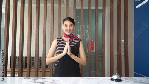 thai receptionist welcome and greeting with Thai wai at hotel thailand photo