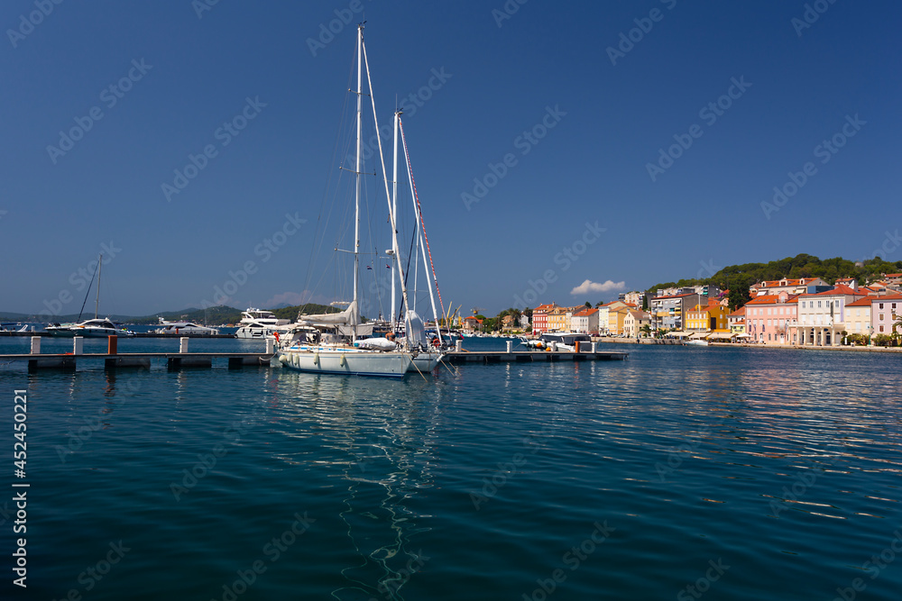 yacht moored at the wooden pier in harbour of Losinj town, Croatia.