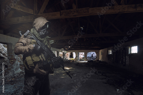 man in gas mask wandering through abandoned settlement.