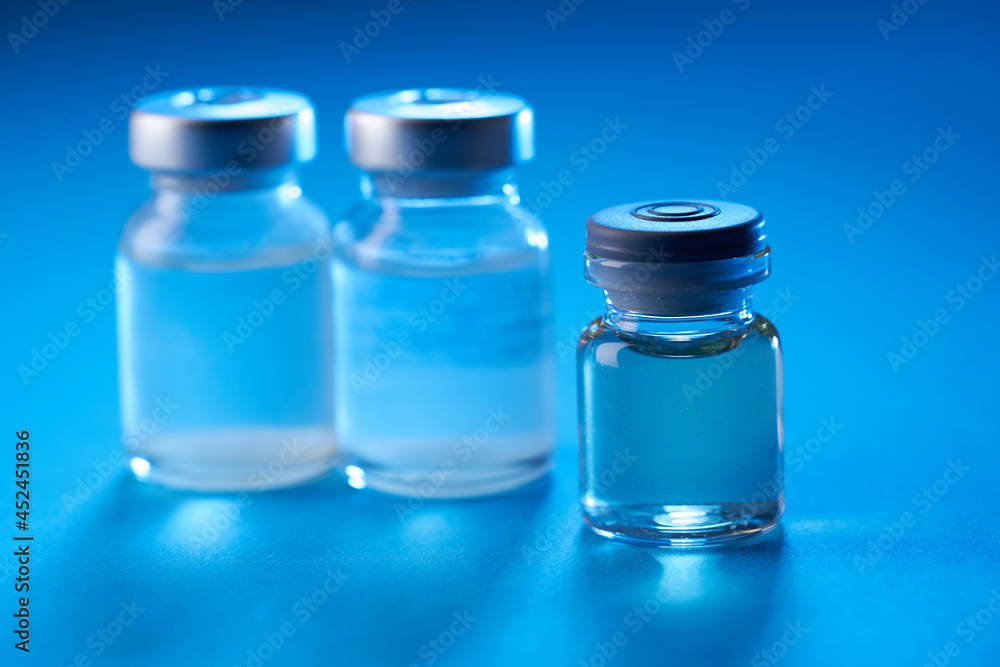 vaccine bottle on the blue background vaccine bottle on the blue background