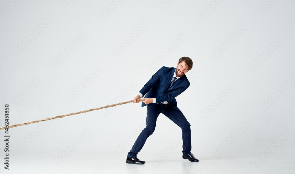 a man in a suit pulling a rope office manager teamwork a man in a suit pulling a rope office manager teamwork
