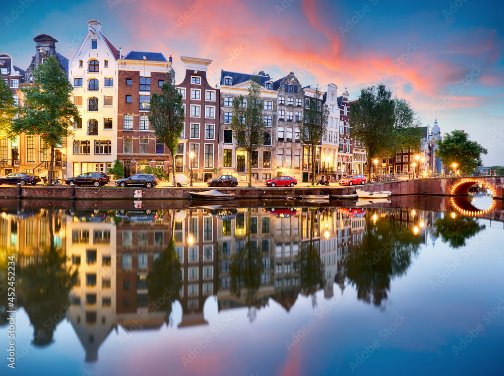 Sunset city view of Amsterdam, the Netherlands with Amstel river