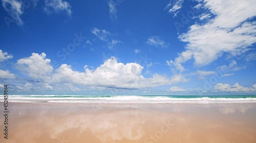 4K Beautiful tropical beach with blue sky and clouds. Tropical beach with waves crashing empty beach. Andaman Phuket beach Thailand. Sea sand and sky on beautiful summer day holiday vacation freedom