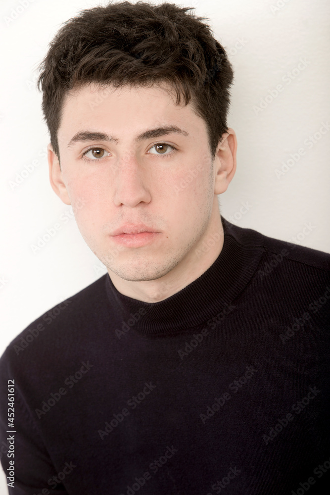 portrait of handsome caucasian boy looking at camera with serious expression portrait of handsome caucasian boy looking at camera with serious expression