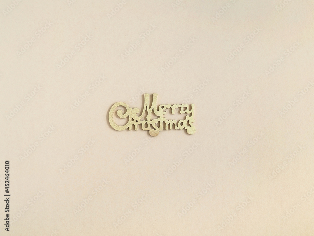 Merry Christmas gold greeting message on beige background. Merry Christmas gold greeting message on beige background.
