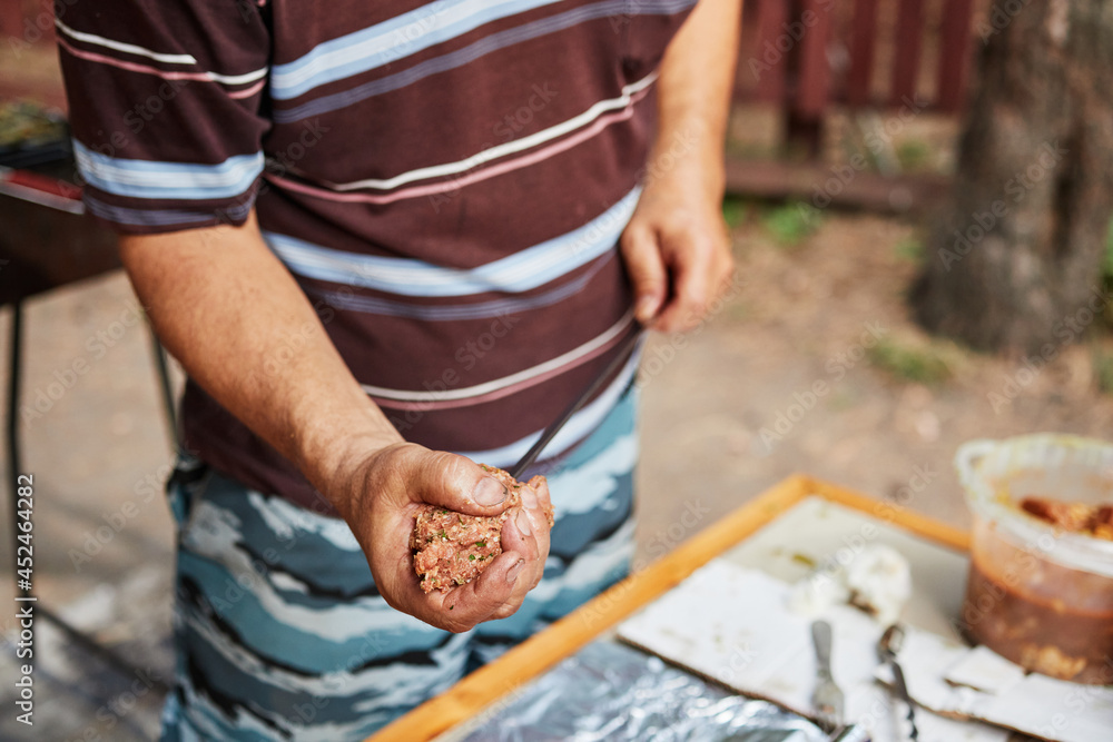 man prepares lula kebab in nature man prepares lula kebab in nature