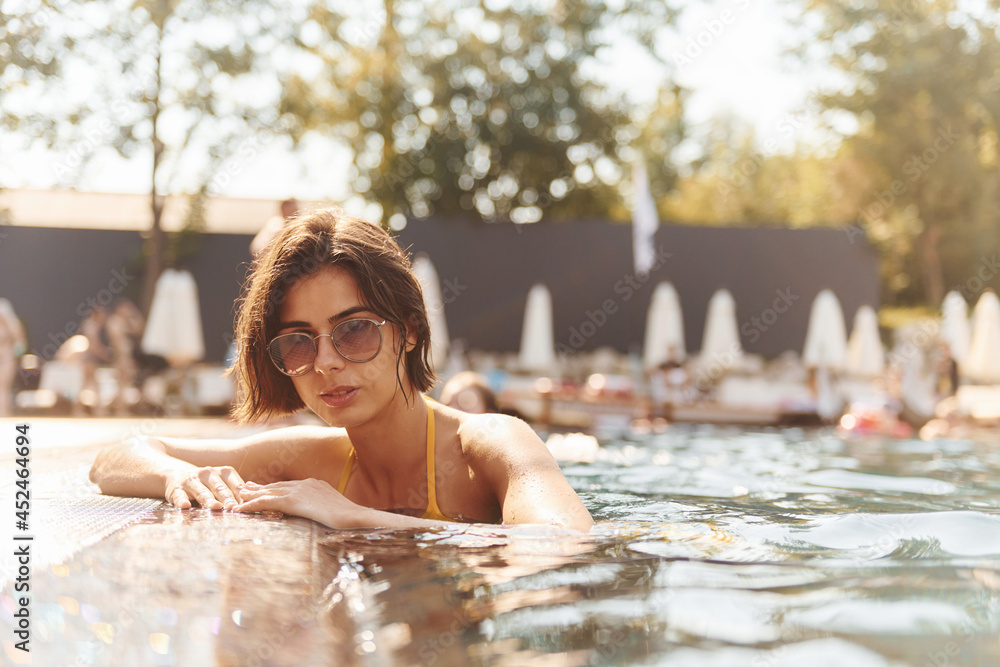 Young woman have a rest in the swimming pool at summertime