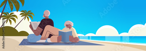 senior couple reading books at beach old man and woman family spending time together relaxation retirement