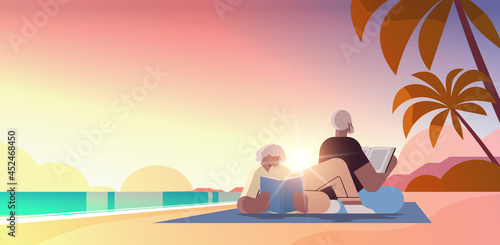 senior couple reading books at beach old man and woman family spending time together relaxation retirement