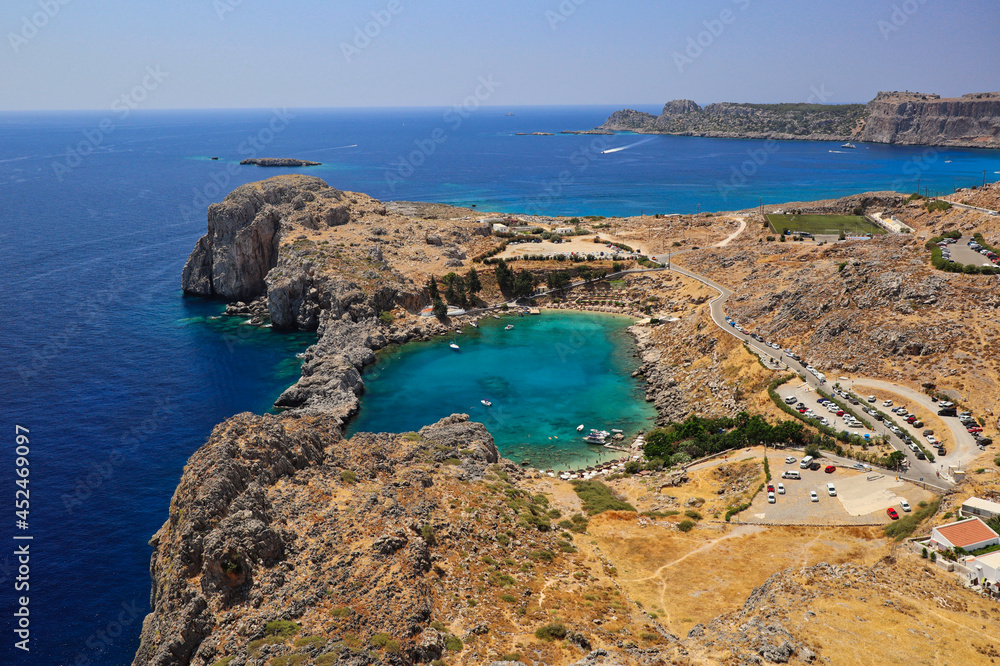 View of St Paul Bay in Lindos with Aegean Sea During Beautiful Summer Day in Lindos. Saint Paul's Bay in Greek Rhodes. 