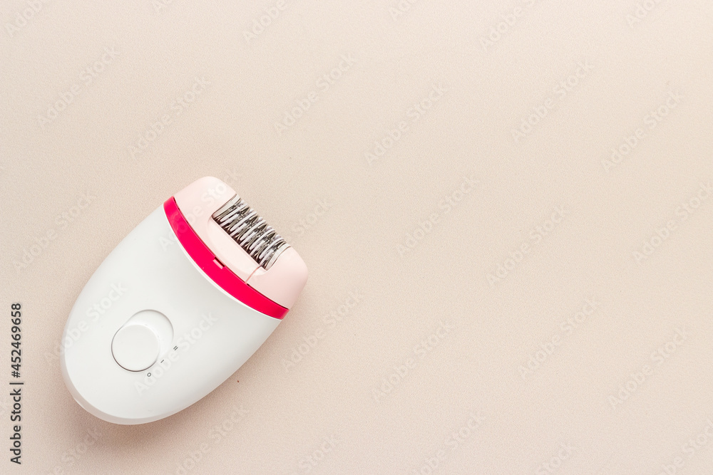 Depilatory - white epilator for hair removal. Depilation, overhead view Depilatory - white epilator for hair removal. Depilation, overhead view