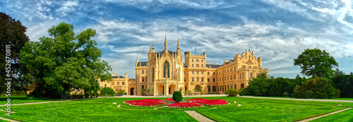 Lednice Chateau extra wide panorama with beautiful sky garden and park on summer day. Lednice - Valtice landscape, Czech South Moravia region. The UNESCO World Heritage Site.