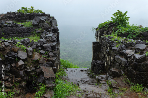 Fallen walls of Tikona Fort shot during rainy season, Pune, Maharashtra, India. photo
