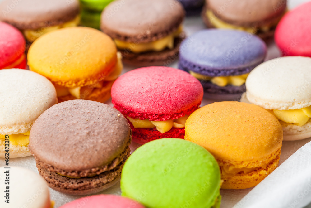 many macaroons on white table many macaroons on white table