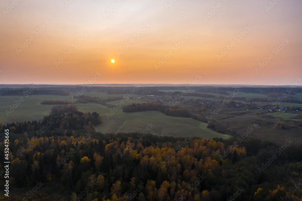 Aerial view of agricultural landscape in autumn season on sunset.