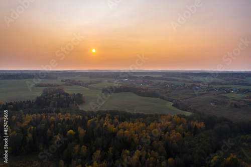Aerial view of agricultural landscape in autumn season on sunset.