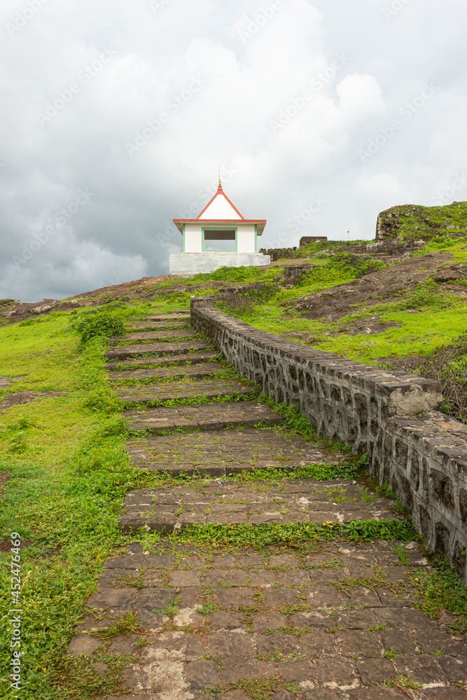 Stairs and the view of Lord Shiva temple on top of the fort, Hatgad fort, Nashik, Maharashtra, India.