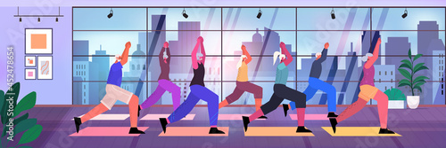 senior people group doing squats on step platform aged men women training in gym aerobic workout healthy lifestyle