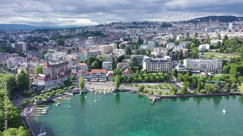 View from Lake Leman of residential areas of Swiss city of Lausanne in cloudy summer day, canton of Vaud in Romandy