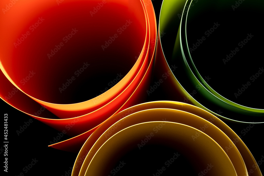 colored plastic sheeting rolls with beautiful shade and shadow on black
