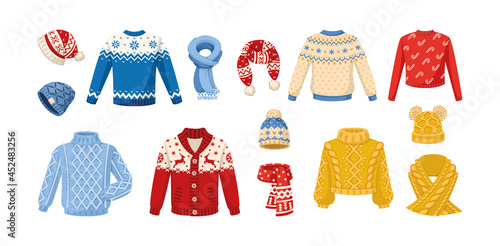 Cute knitted warm winter clothing. Wool knitting winter clothes hats, mittens, Christmas sweaters with festive winter year ornaments, cardigan, jumper, gloves, socks, couple of woolen threads