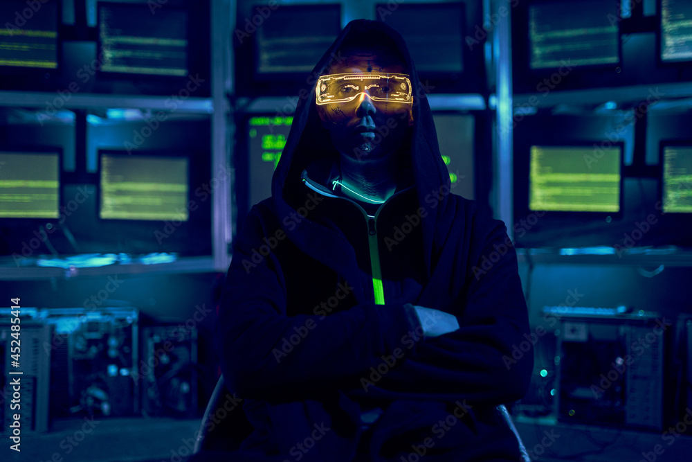 Portrait of a cyber hacker stealing information using a computer.