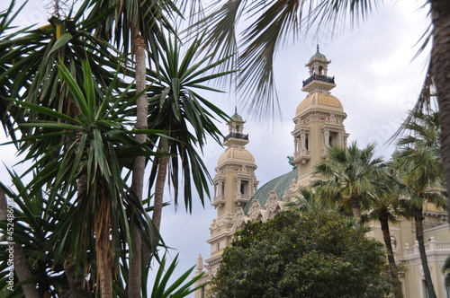 The Monte Carlo Casino, luxury gambling and entertainment building in Monte Carlo, Monaco. View through palms