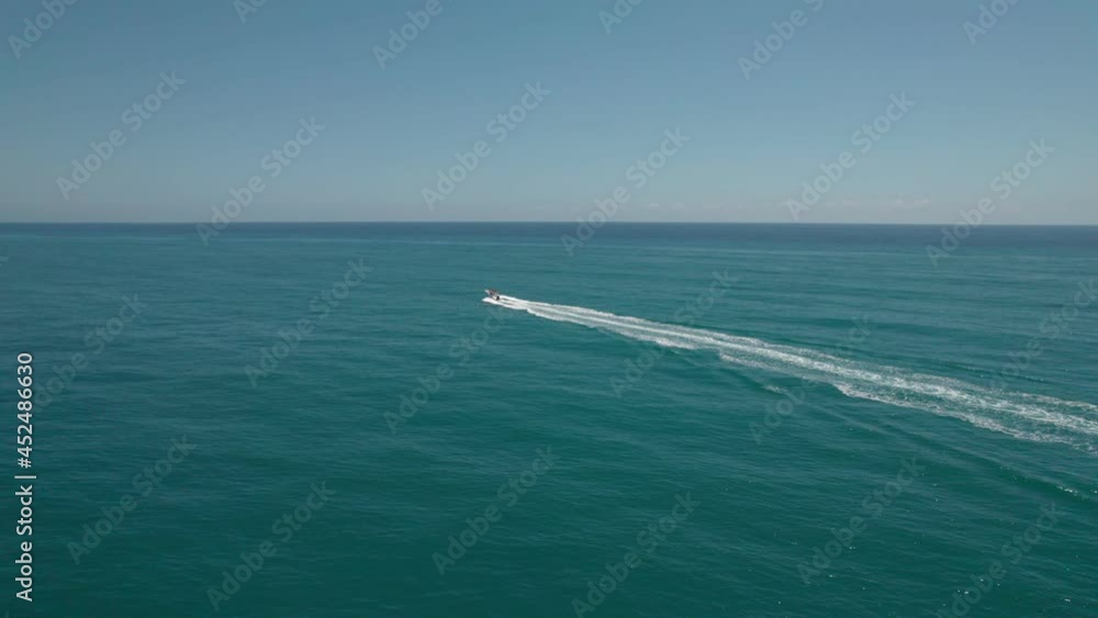 A luxury motor boat sails on the sea during sunrise. A luxury motor boat sails on the sea during sunrise.