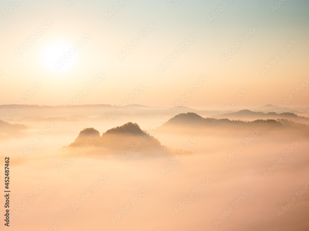 Landscape misty panorama. Fantastic dreamy sunrise above fairy misty valley