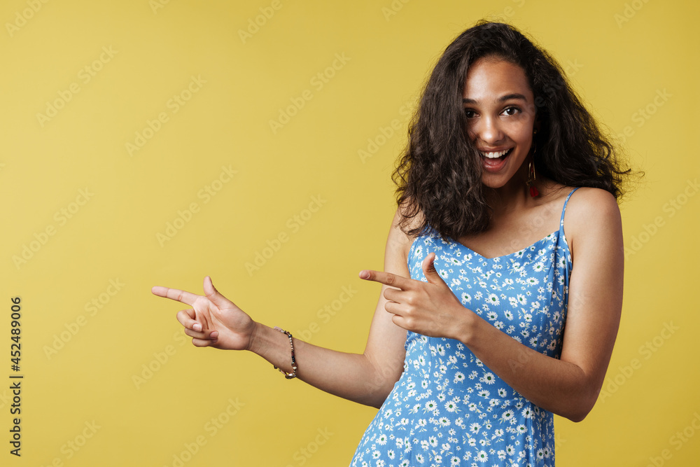 Young hispanic woman laughing while pointing finger aside Young hispanic woman laughing while pointing finger aside