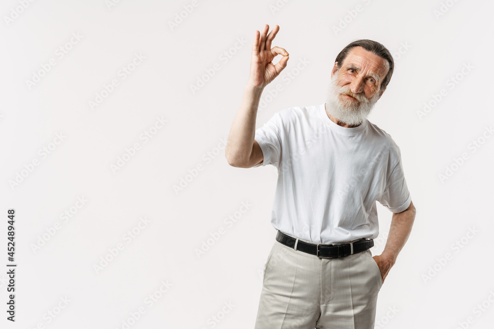 European senior man with beard showing ok gesture at camera European senior man with beard showing ok gesture at camera