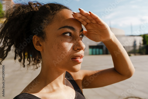 Close up of a smiling young african fitness woman photo