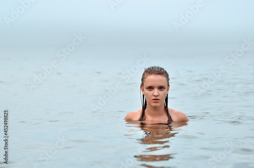 Beautiful young woman in sexy bikini on the sea beach