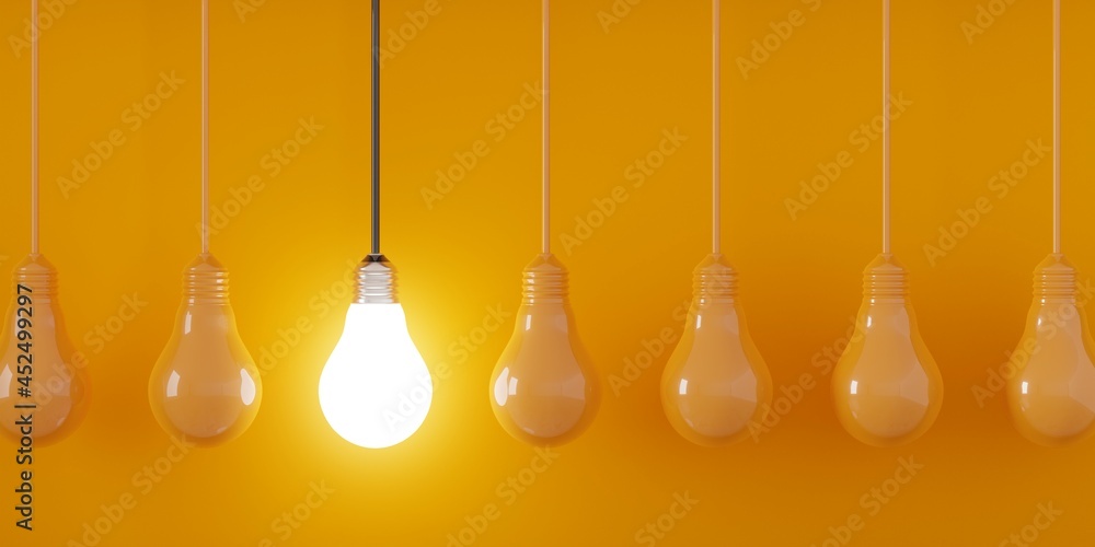 Single glowing lightbulb in row of blue bulbs over dark background, creativity, uniqueness or standing out concept Single glowing lightbulb in row of blue bulbs over dark background, creativity, uniqueness or standing out concept