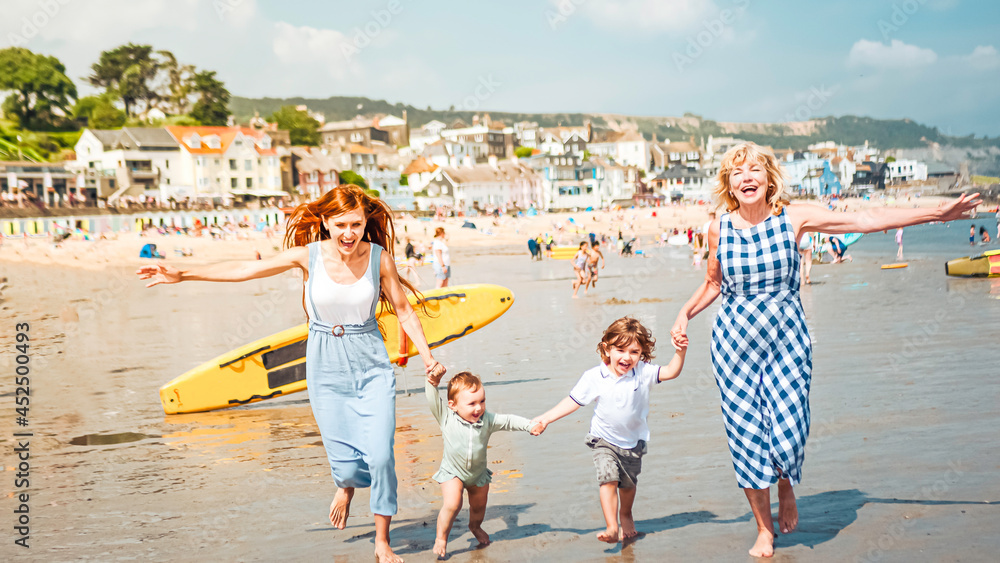 Multigenerational family is joyful and reunited during their summer holidyas in Lyme Regis, United Kingdom