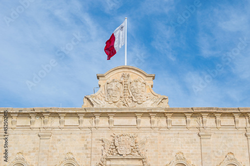 VALLETTA, MALTA - Jan 07, 2021: A coat of arms sculpture on the Auberge de Castille, now used as Office of Prime Minister of Malta photo