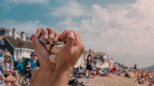 Hands in a heart shape at Lyme Regis touristic beach in July middle of summer in the United Kingdom