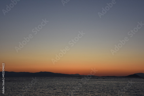 sunset on the sea over the port in Aegina in Greece