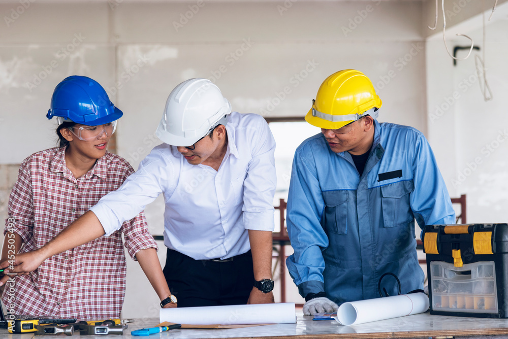 Construction engineer teamwork Safety Suit Trust Team Holding White Yellow Safety hard hat Security Equipment on Construction Site. Hardhat Protect Head for Civil Construction Engineer Concept Construction engineer teamwork Safety Suit Trust Team Holding White Yellow Safety hard hat Security Equipment on Construction Site. Hardhat Protect Head for Civil Construction Engineer Concept