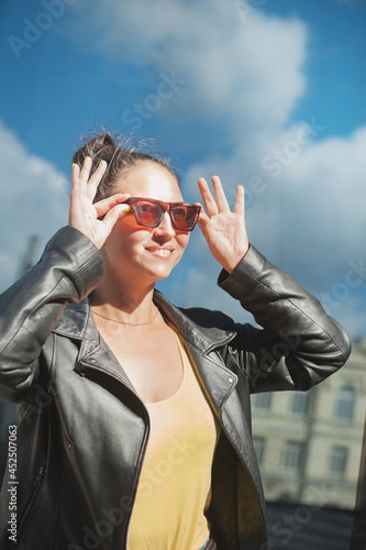 Beautiful happy woman with sunglasses on the sky background © darkbird