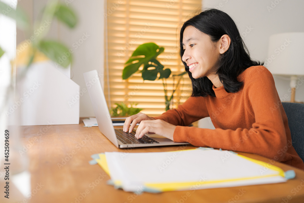 Asian girl student learning online via the internet with tutor on laptop Asian girl student learning online via the internet with tutor on laptop