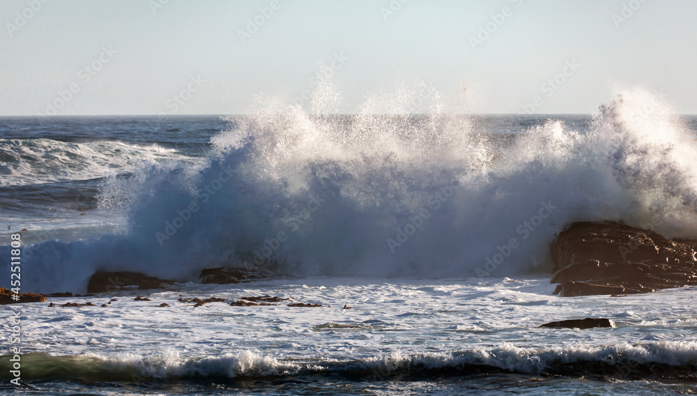Fototapeta premium High storm wave with foam and spray breaks on the shore.