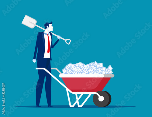 Hold on the shovel next to wheelbarrow full of strapped cash banknote bundles