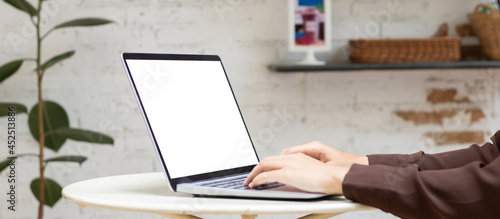 Wallpaper Mural Woman using or typing laptop outside cafe restaurant with natural. Laptop computer on white desk and white blank on screen. Torontodigital.ca