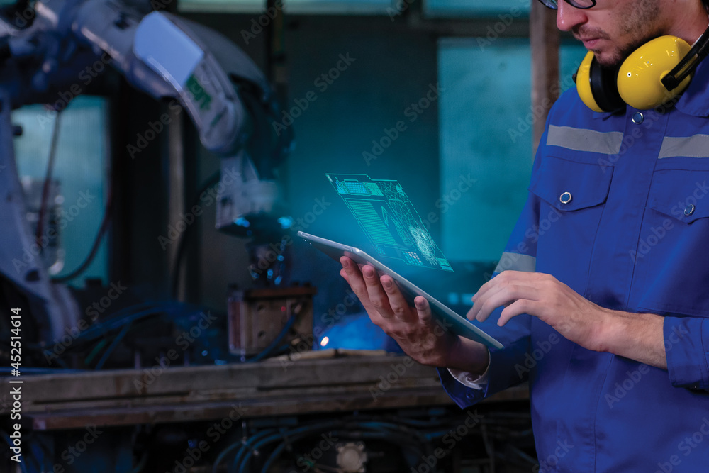 Engineer check and control automation robot arms.Robot arms machine in intelligent factory industrial on monitoring system software. Welding robotics and digital manufacturing operation. Engineer check and control automation robot arms.Robot arms machine in intelligent factory industrial on monitoring system software. Welding robotics and digital manufacturing operation.