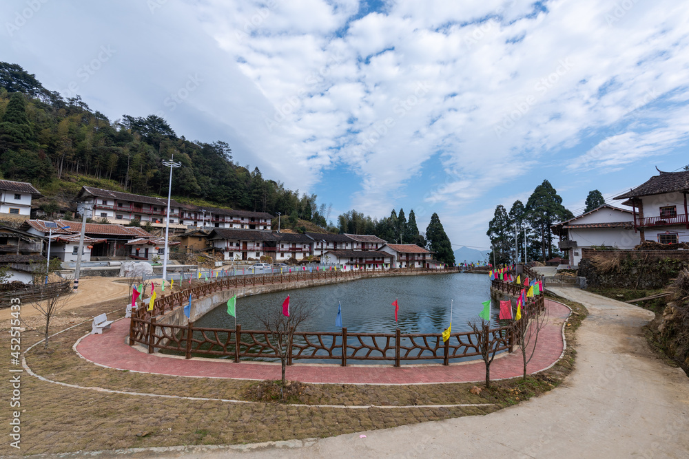 Fototapeta premium Beautiful mountain village, with lake, blue sky, house and grassland