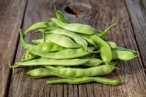 fresh ripe green beans on wood background. Close up