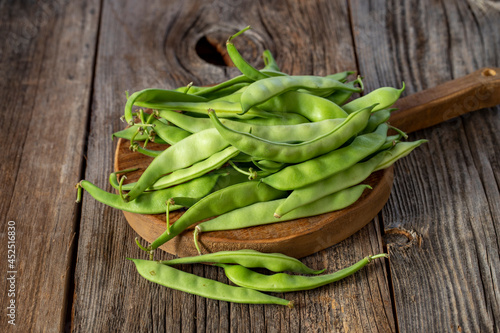 fresh ripe green beans on wood background
