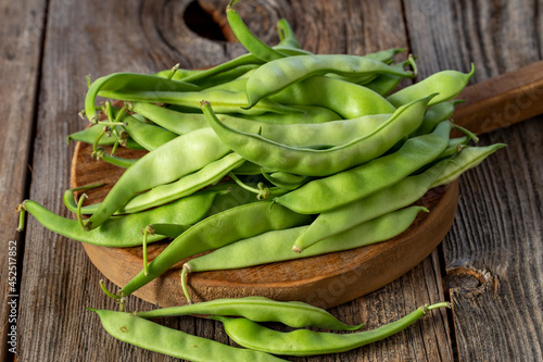 fresh ripe green beans on wood background. Close up