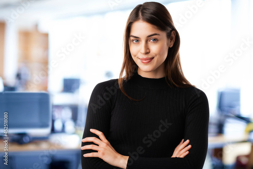 Smiling young businesswoman portrait while standing at the office